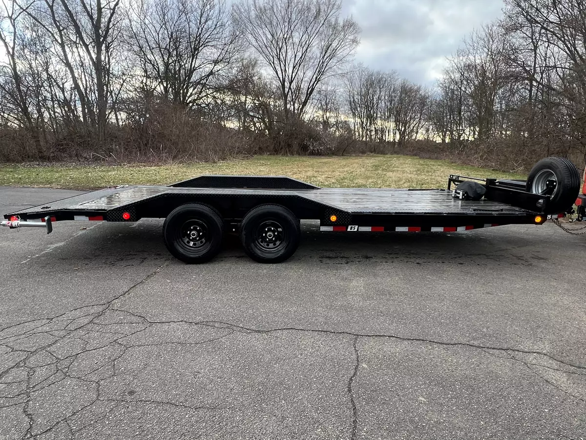 PJ 20CH 20ft car hauler trailer full side view on pavement displaying diamond plate fenders and LED lights