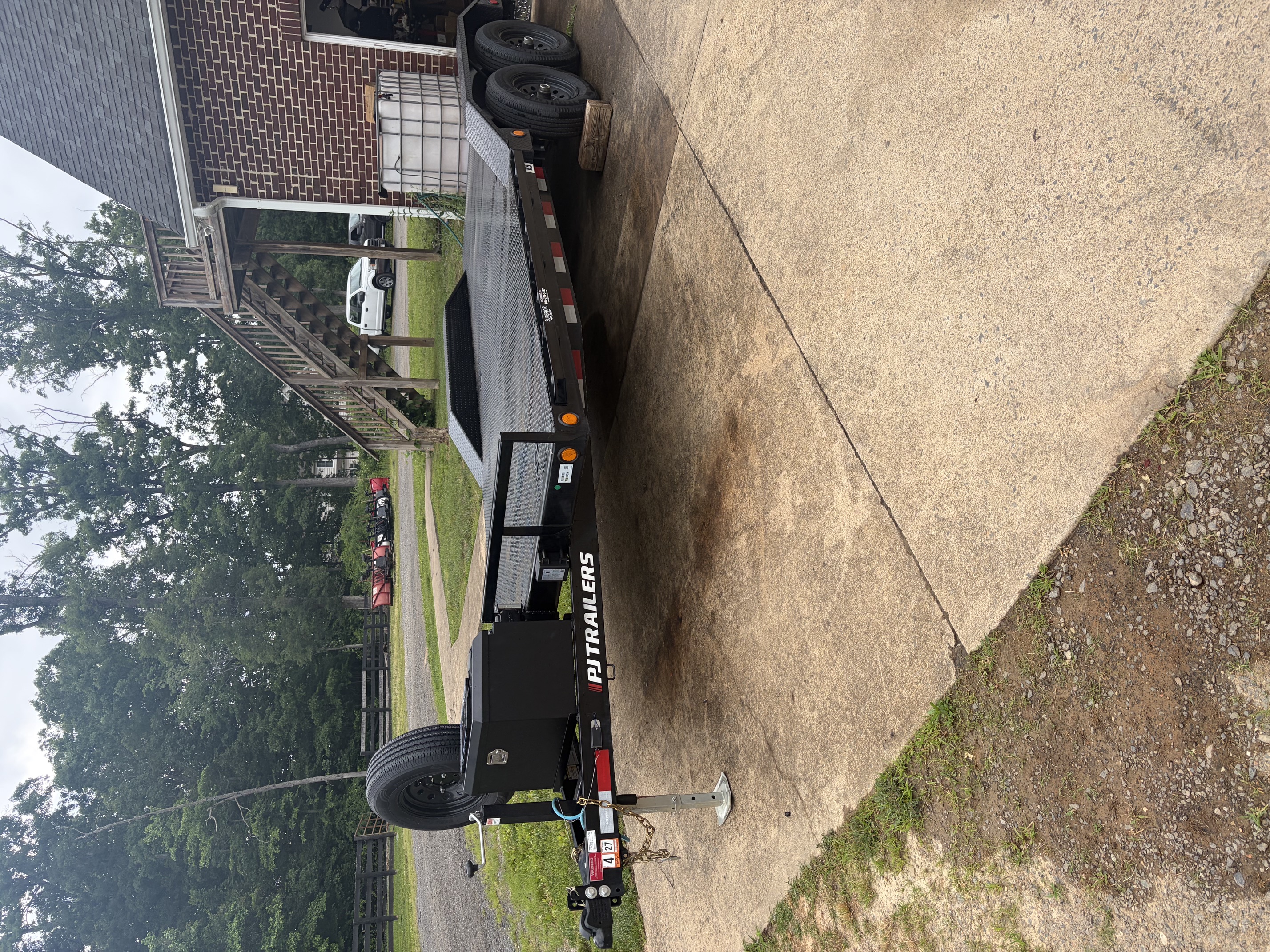 PJ Trailers car hauler trailer side profile showing full length flatbed deck and dual axles
