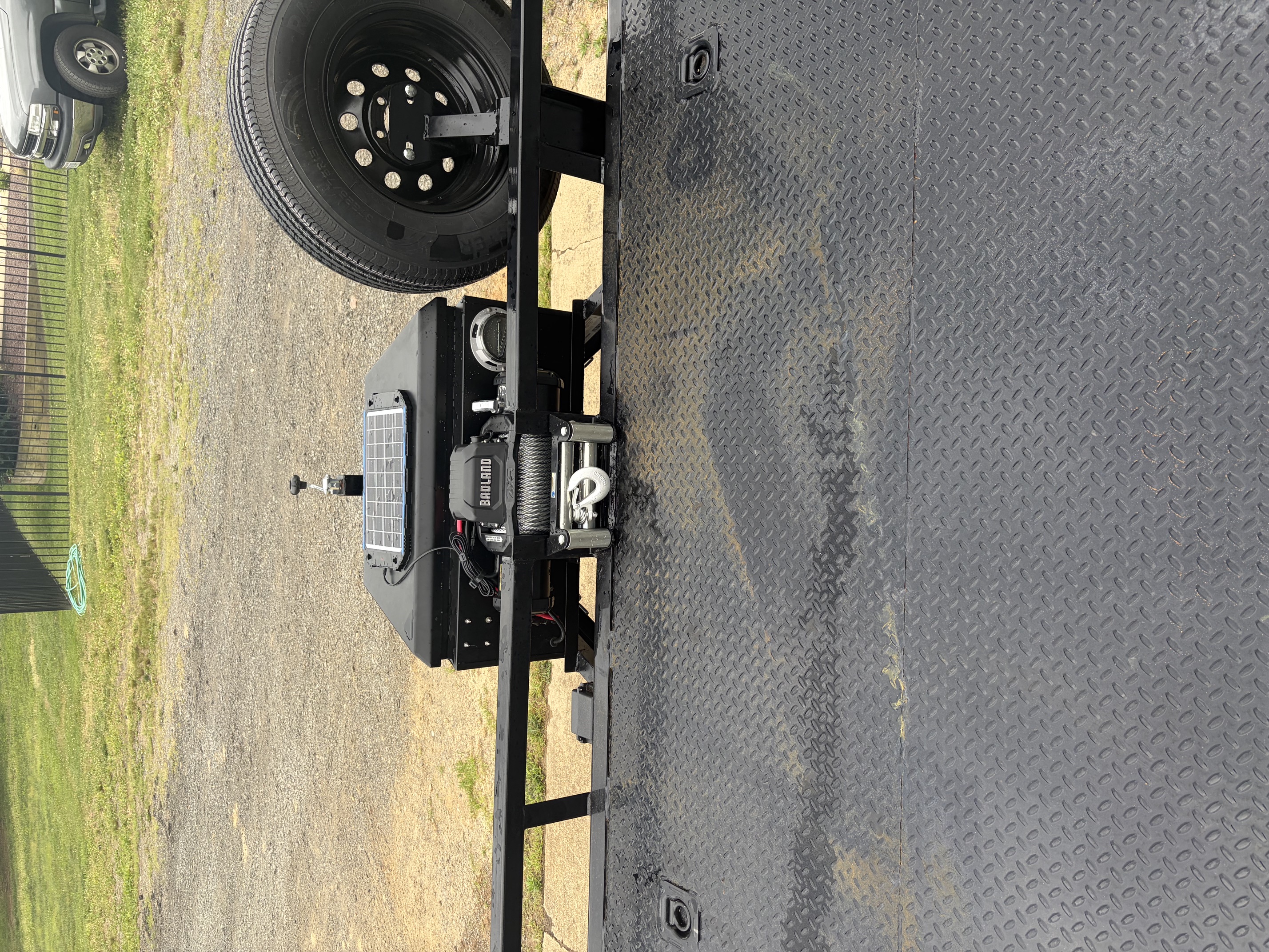 Badland winch and solar charger mounted on front of car hauler trailer with spare tire